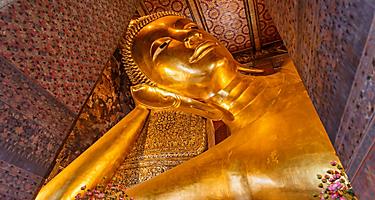 The reclining buddha gold statue face in Wat Pho Bangkok, Thailand