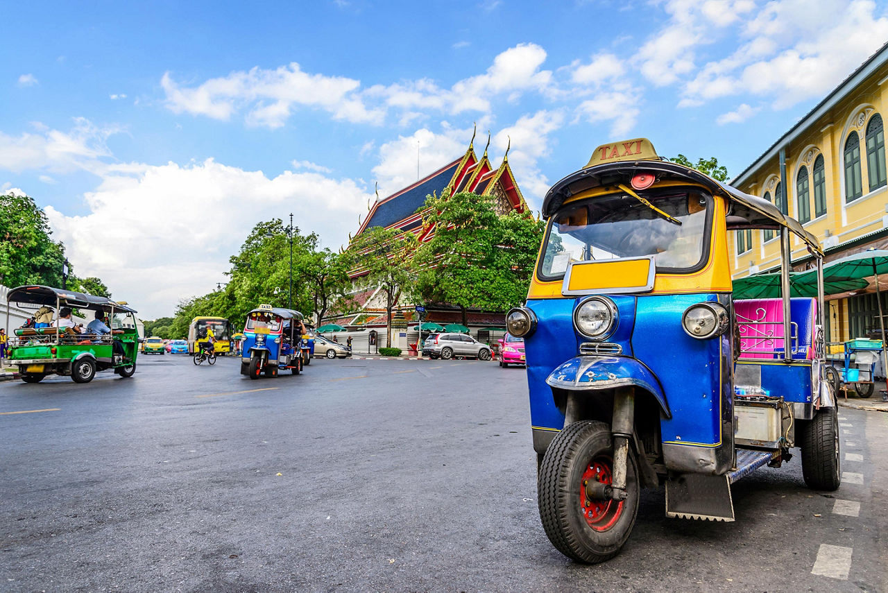 The blue tuk tuk is the traditional taxi car in Bangkok