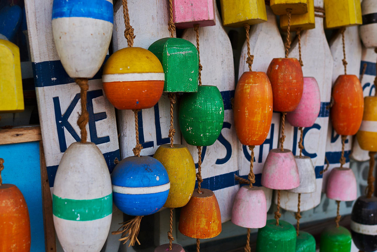 An assortment of colorful wooden float souvenirs in Bar Harbor, Maine