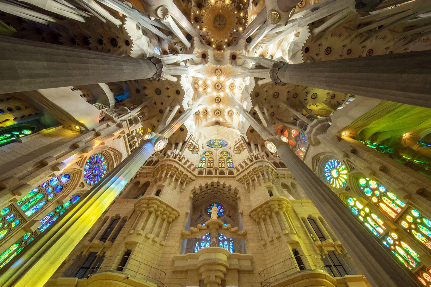 Soft light filters through Sagrada Família’s soaring interior, illuminating sculpted columns and warm stone. - Barcelona, Spain