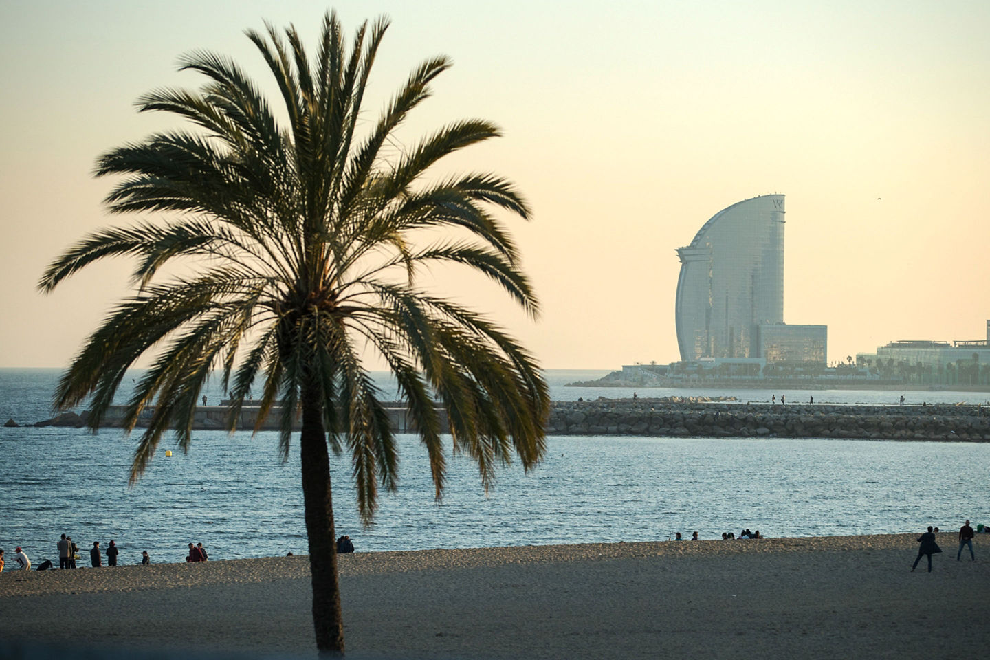 Barceloneta Beach combines city access with sun, sea, and seaside dining for a quintessential Barcelona experience. - Barcelona, Spain