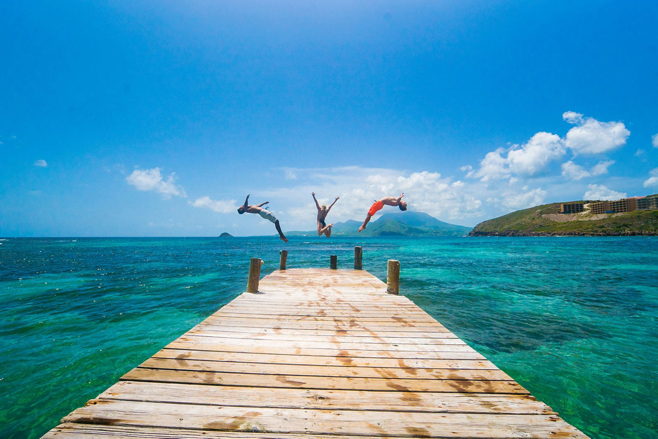 Friends Jumping in Ocean. Basseterre, St. Kitts Nevis 
