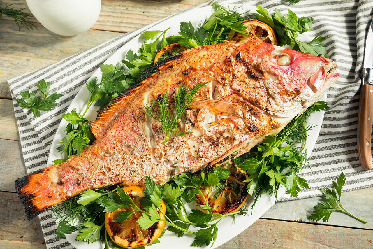 Grilled whole red snapper with lemons and dill