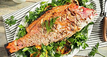 Grilled whole red snapper with lemons and dill