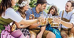 Five friends having fun on Bavarian RIver and clinking glasses with Oktoberfest