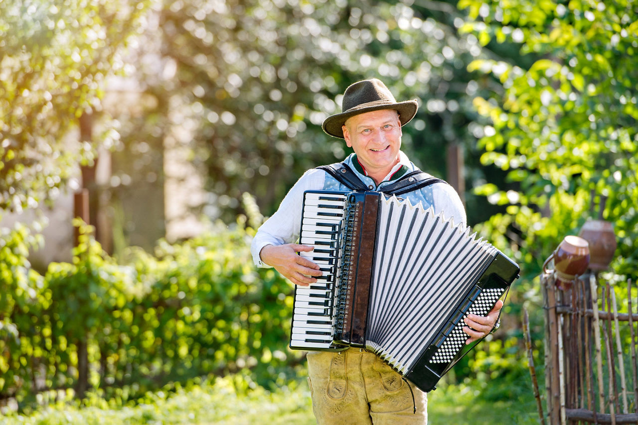 Man in traditional bavarian clothes playing the accordion