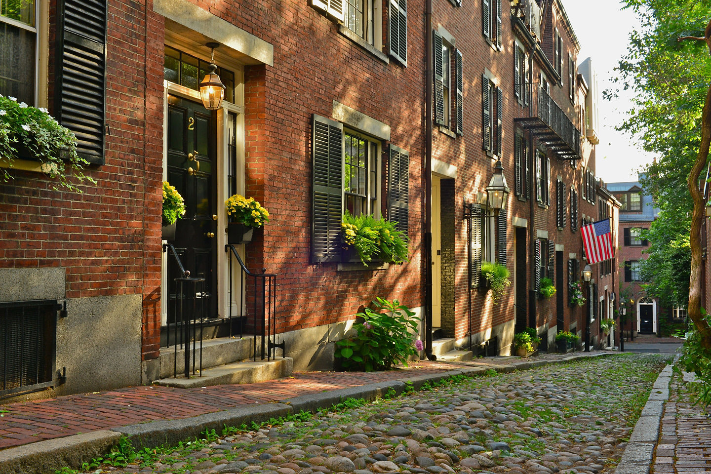 Acorn Street’s narrow cobblestone lane is lined with brick homes and classic Boston gas lamps in Beacon Hill. - Boston, Massachusetts