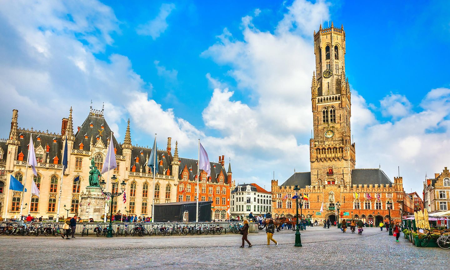The central Markt square buzzes with cafés and markets, crowned by the Belfry’s panoramic tower climb. - Bruges, Belgium