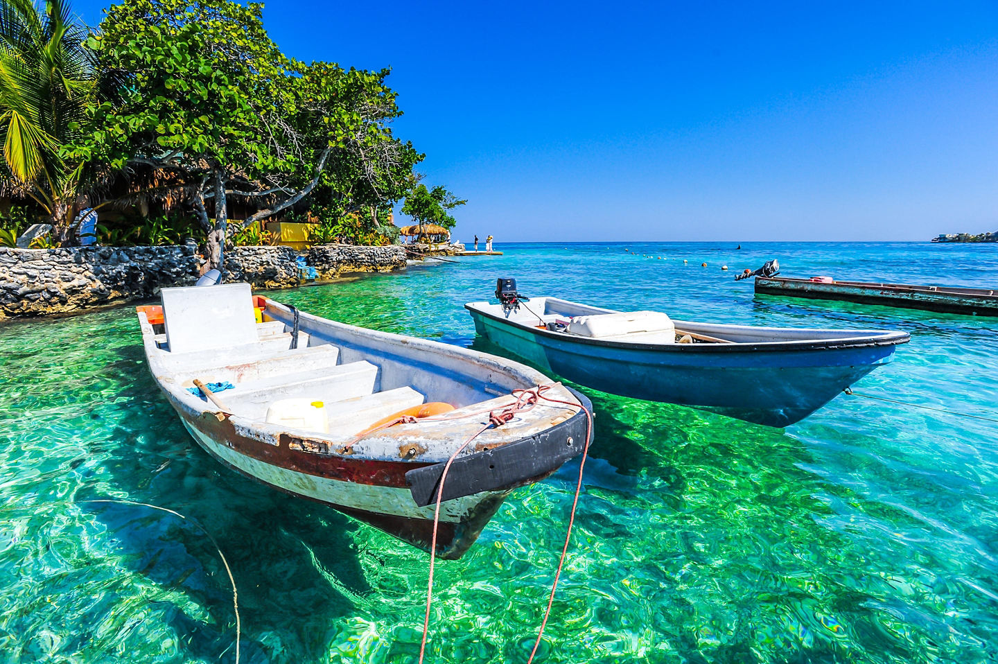 The Rosario Islands' clear turquoise water surrounds small green islands under a bright Caribbean sun. - Cartagena, Colombia