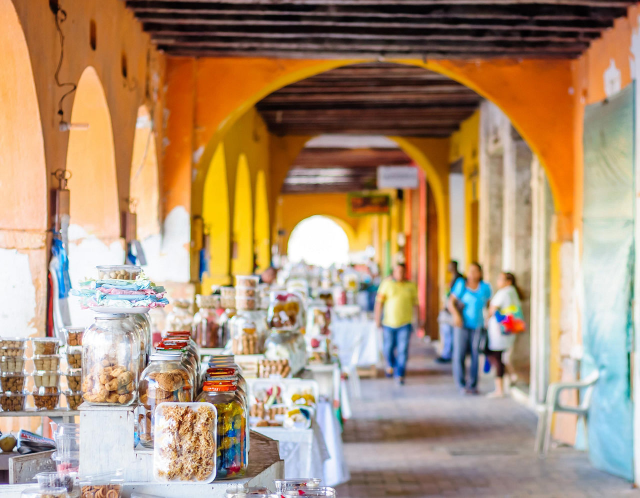 An outdoor market under a covered walkway in Cartagena, Colombia