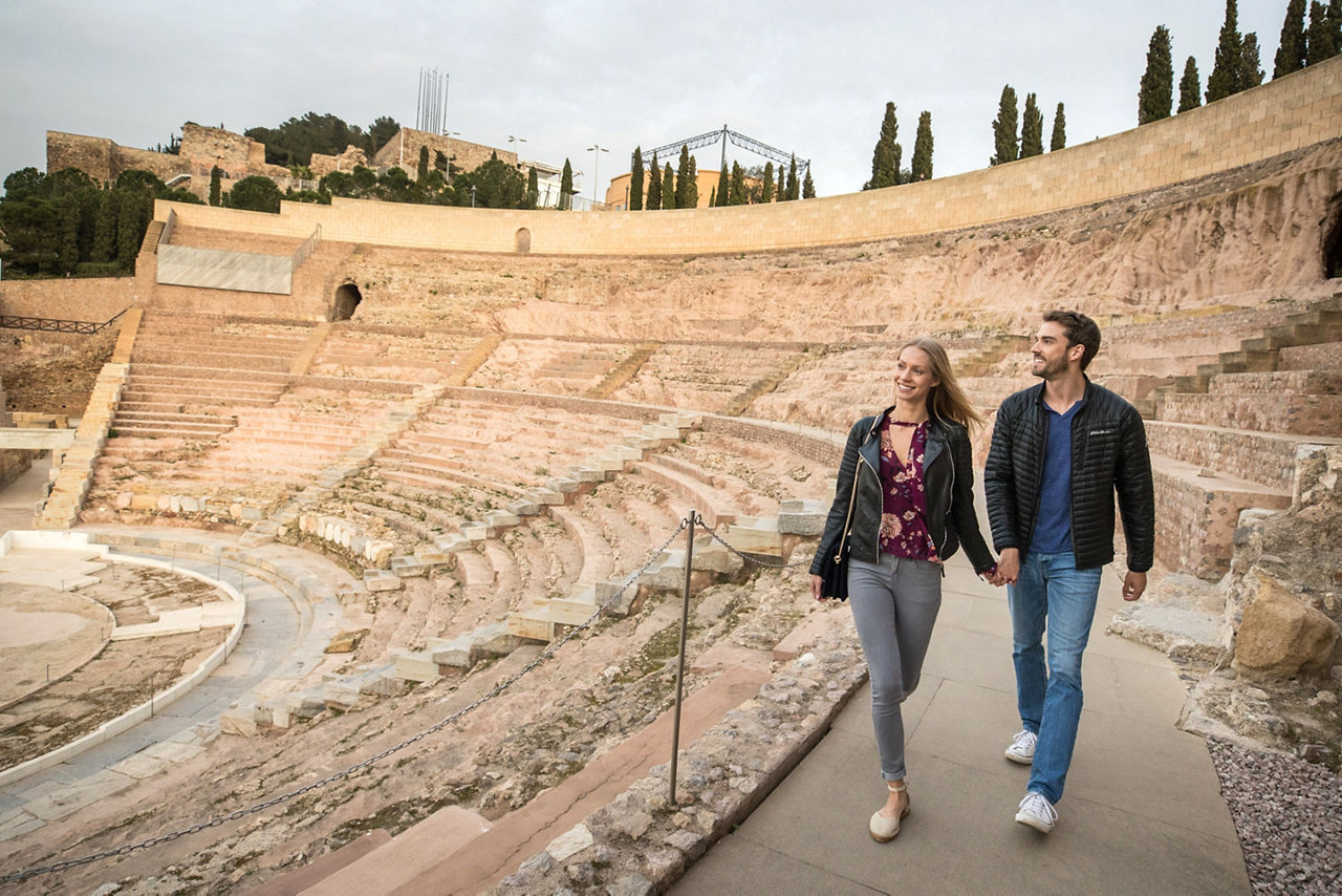 Couple Walking Through Spain's Roman Theater