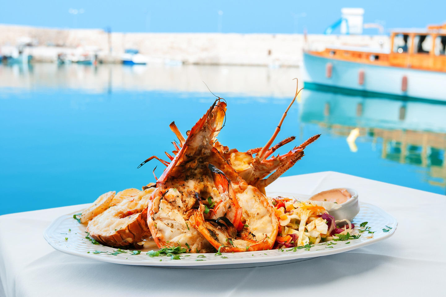 Lobster is served with fresh vegetables, highlighting Crete’s bright, Mediterranean coastal cuisine. - Chania, Crete