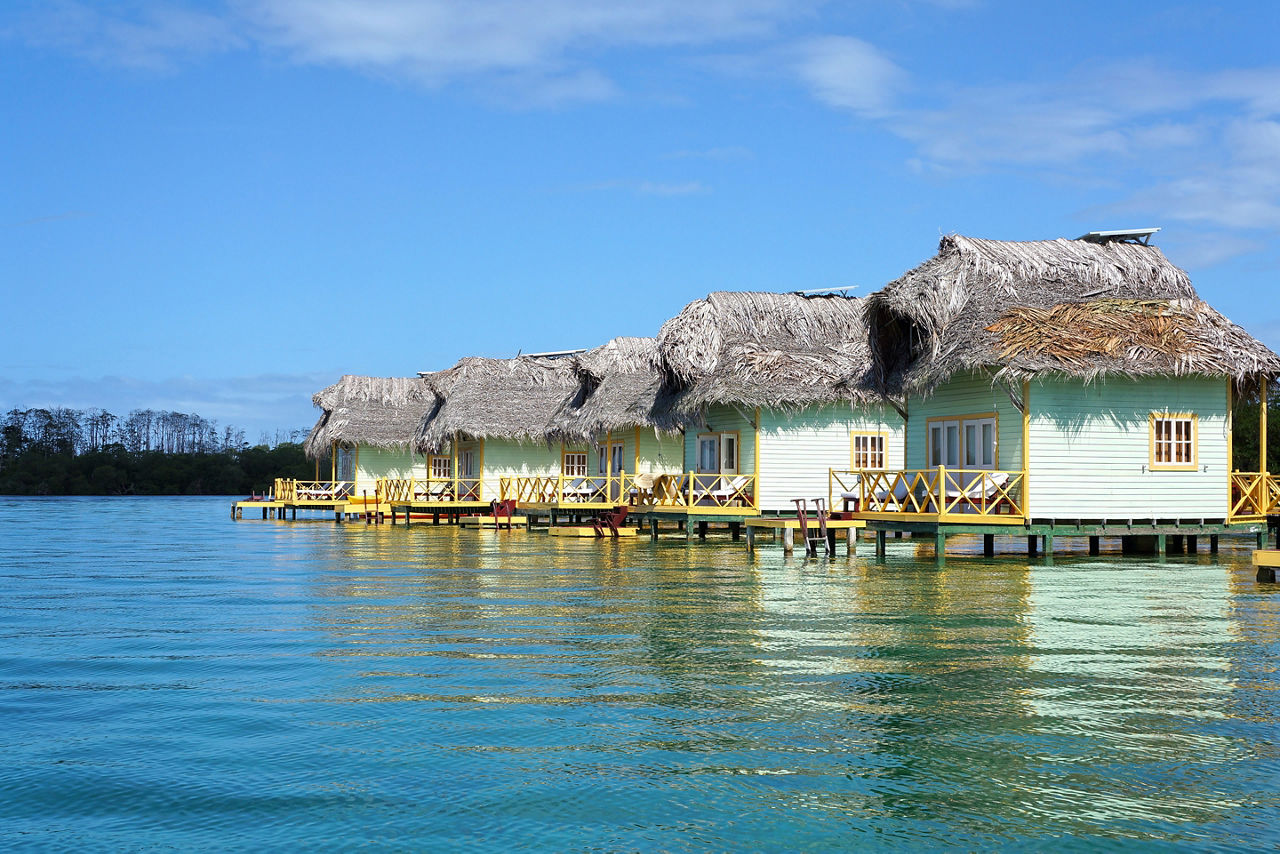 Tropical eco resort with thatched cabins over the sea, Colon island