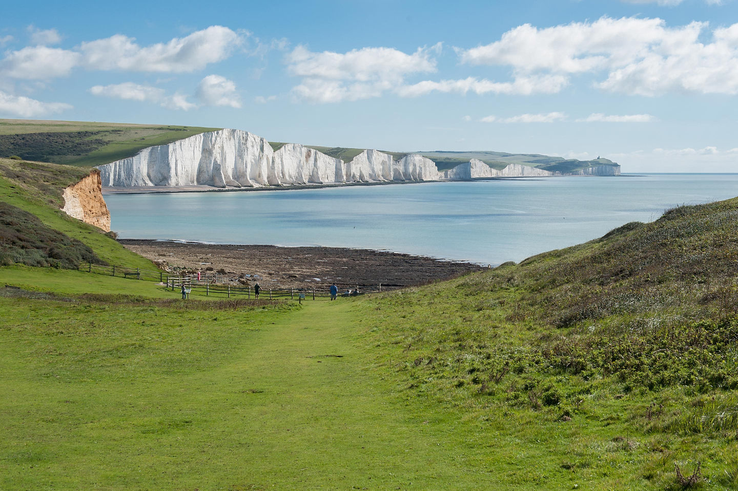 White chalk cliffs rise sharply above the sea. - Dover, England