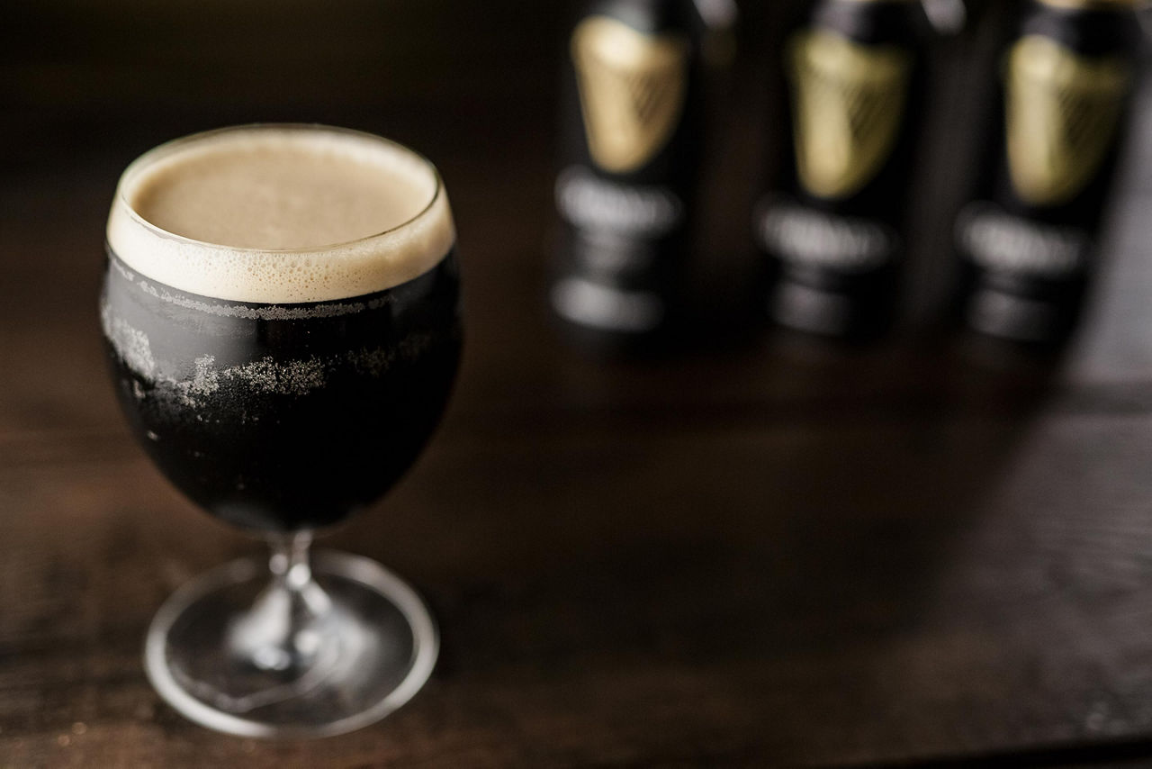 A glass filled with a dark Irish stout beer
