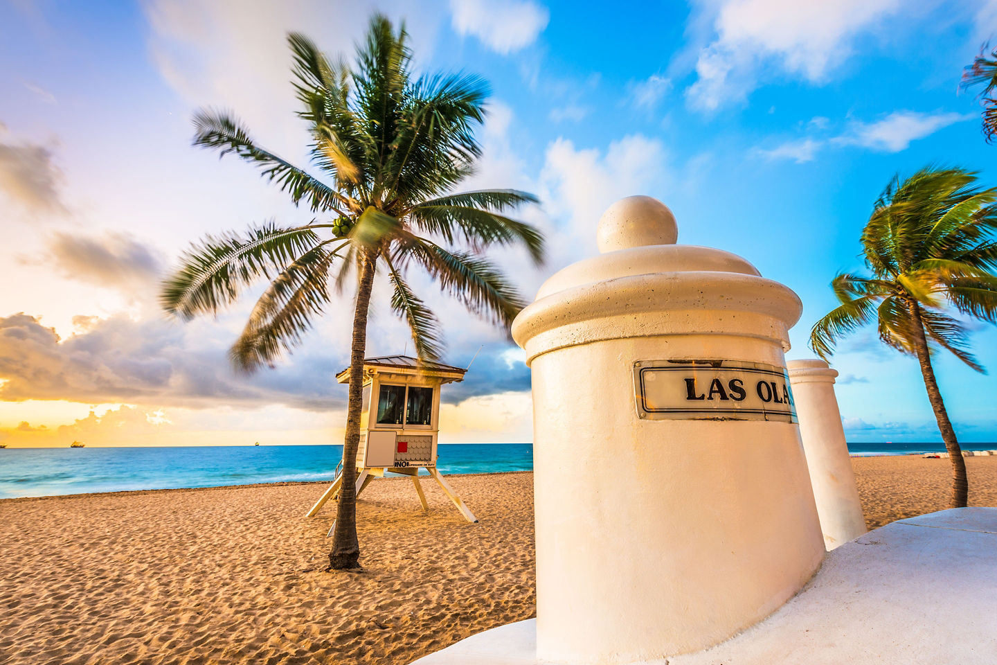 Las Olas Beach shoreline with sunlit sand and blue waters. - Fort Lauderdale, Florida