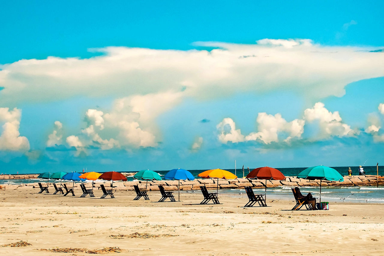 Row of colorful beach umbrellas on the beach. Galveston, Texas.