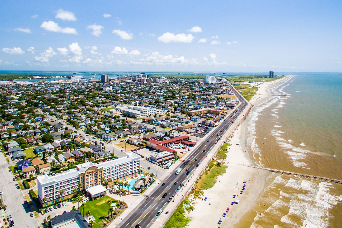 Aerial view of Galveston’s coastline, port facilities, and waterfront cityscape. - Galveston, Texas