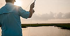 Man fly fishing at sunset in Galveston. Texas.