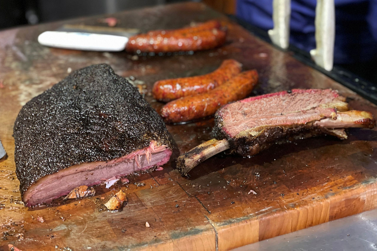 Smoked sausage, ribs, and beef brisket at a BBQ Restaurant in Austin, TX.