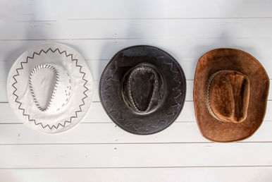 white wooden wall cowboy hats hung texas ranchers house galveston