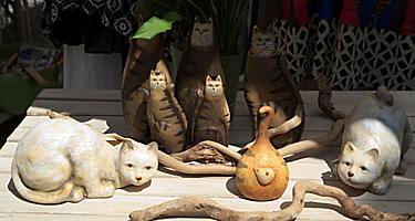 An assortment of souvenir cat statues