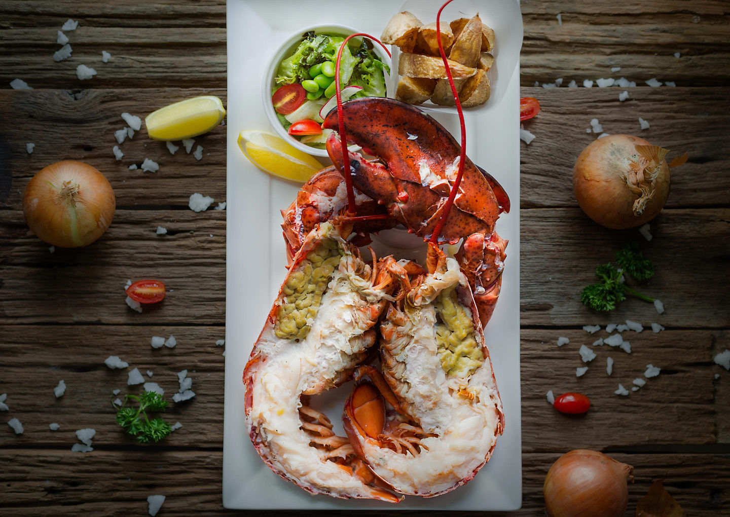 A freshly steamed lobster sits on a plate, showcasing Halifax’s classic coastal seafood tradition. - Halifax, Nova Scotia