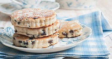 Four welsh griddle cakes on a blue and white plate