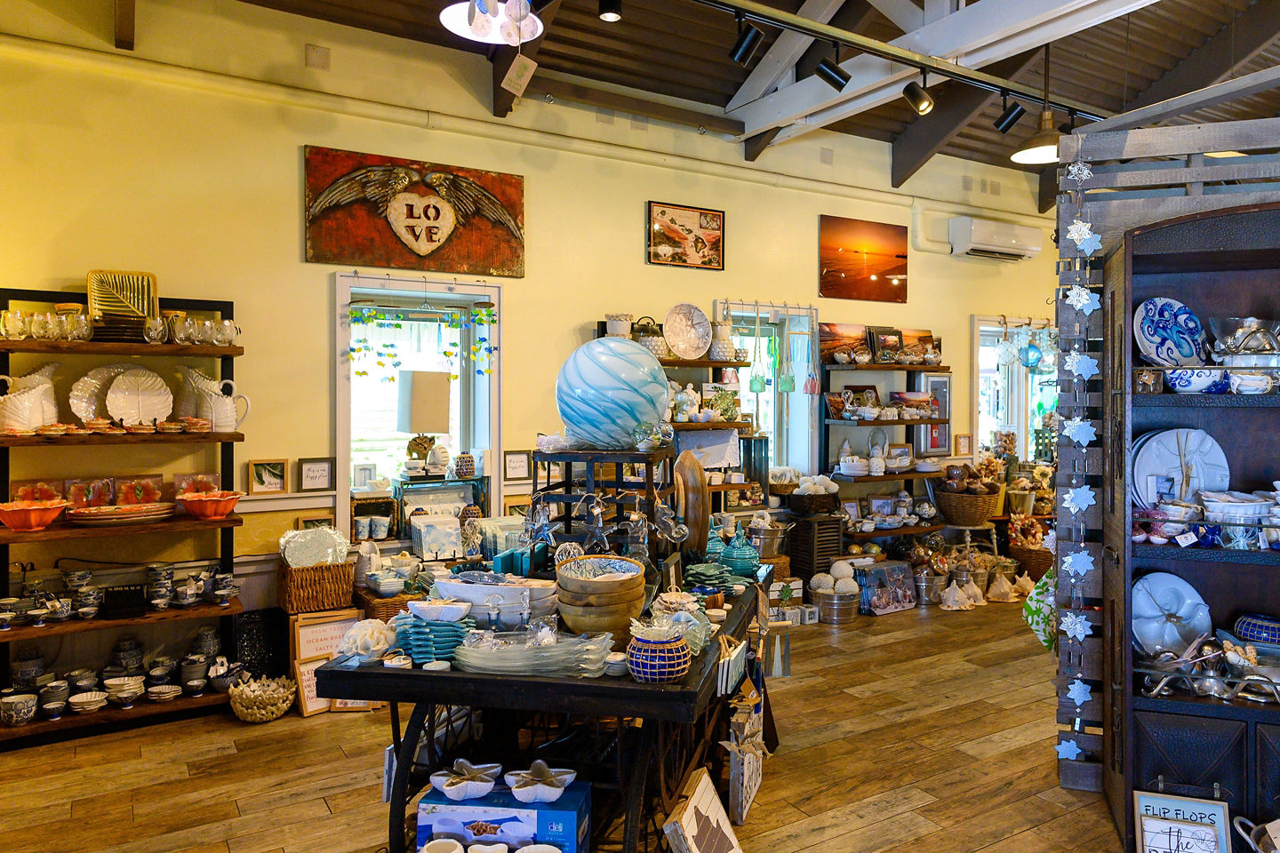 Colorful Polynesian-inspired clothing and crafts are displayed inside a store. - Honolulu, Hawaii