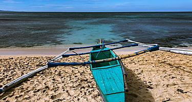 Blue boat docked by the shore in Ilocos, Philippines