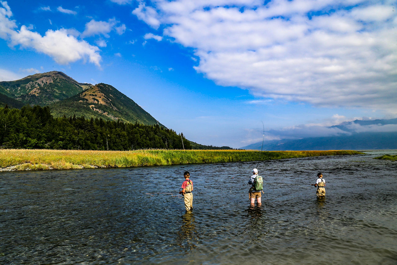 Boys fly fishing for salmon on Resurrection Creek in Hope, Alaska