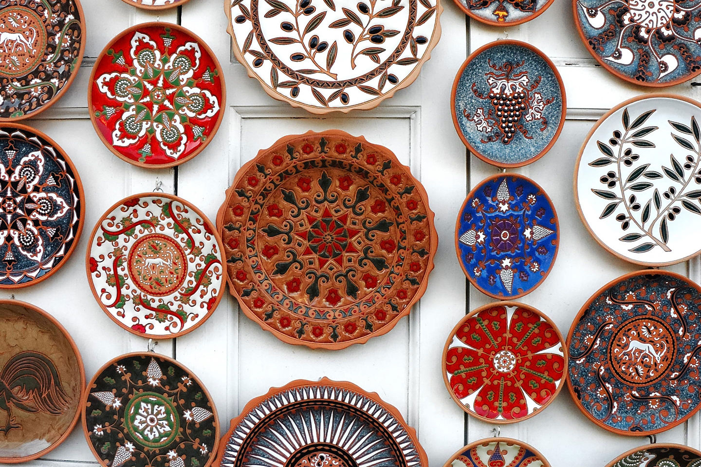 Colorful painted plates featuring bright Greek ceramic designs. - Olympia, Greece