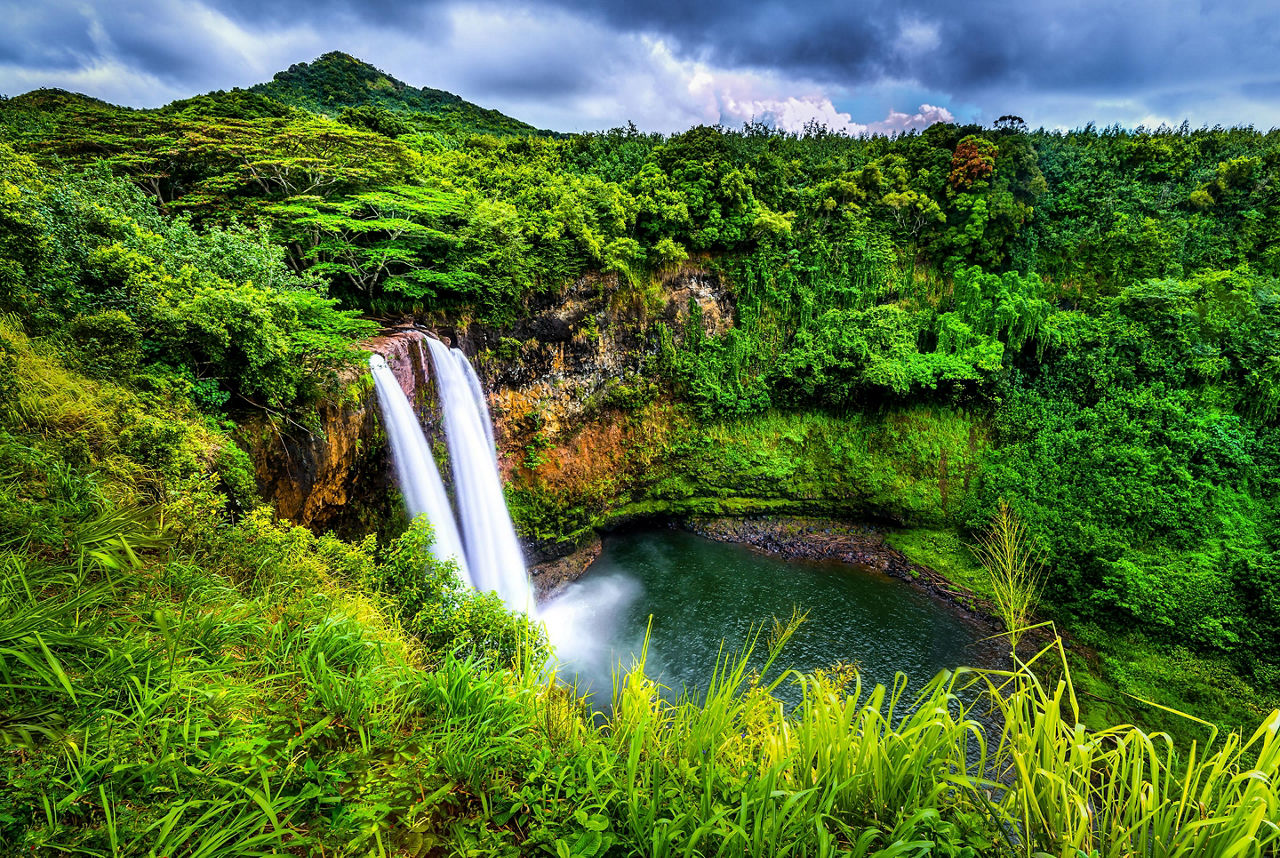 Beautiful luscious landscape surrounding the waterfalls called Wailua Falls in Kauai, Hawaii