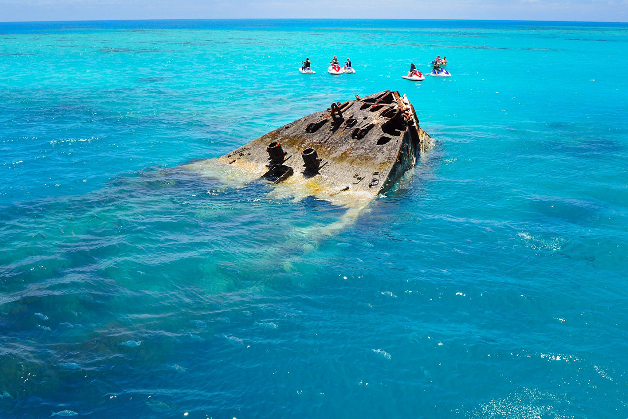 Group Jet Skiing near a Shipwreck in the Clear Turquoise Waters, Bermuda