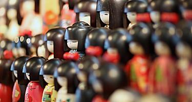 Traditional wooden japanese dolls sold in souvenir shops in Japan