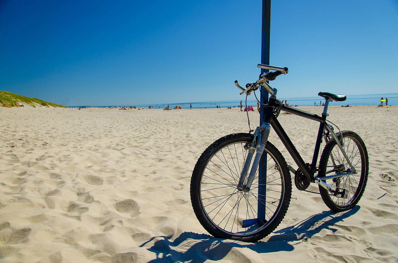 A bicycle resting on a pole at a beach in Klaipeda, Lithuania
