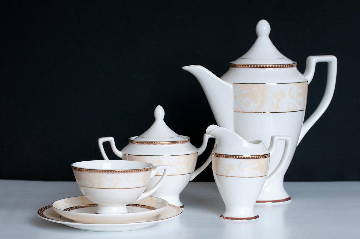 A traditional Japanese tea set displays ceramic cups and a teapot arranged neatly on a wooden tray. - Kobe, Japan