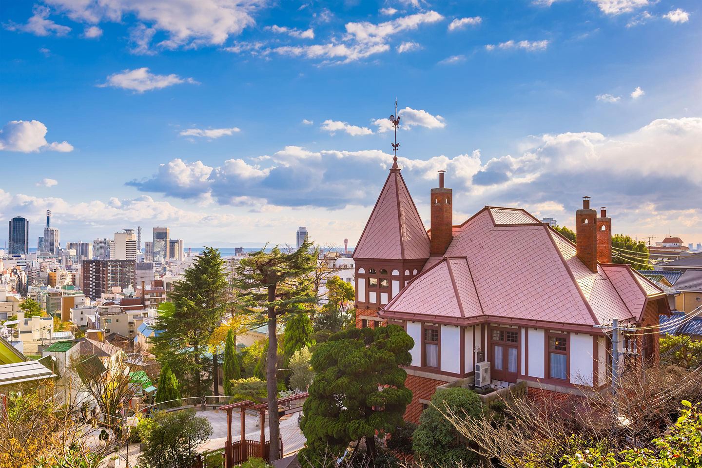 Historic Kitano district homes feature Western‑style architecture, sloped roofs, and tree‑lined walkways in Kobe. - Kobe, Japan