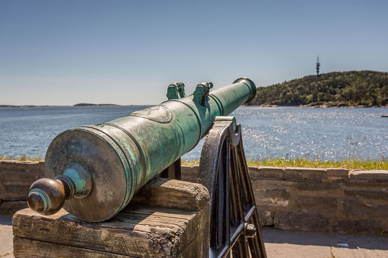 A vintage cannon overlooking the ocean in Kristiansand, Norway