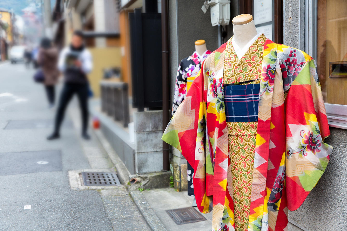 A patterned kimono hangs neatly, showcasing traditional Japanese colors and detailed woven designs. - Kyoto, Japan