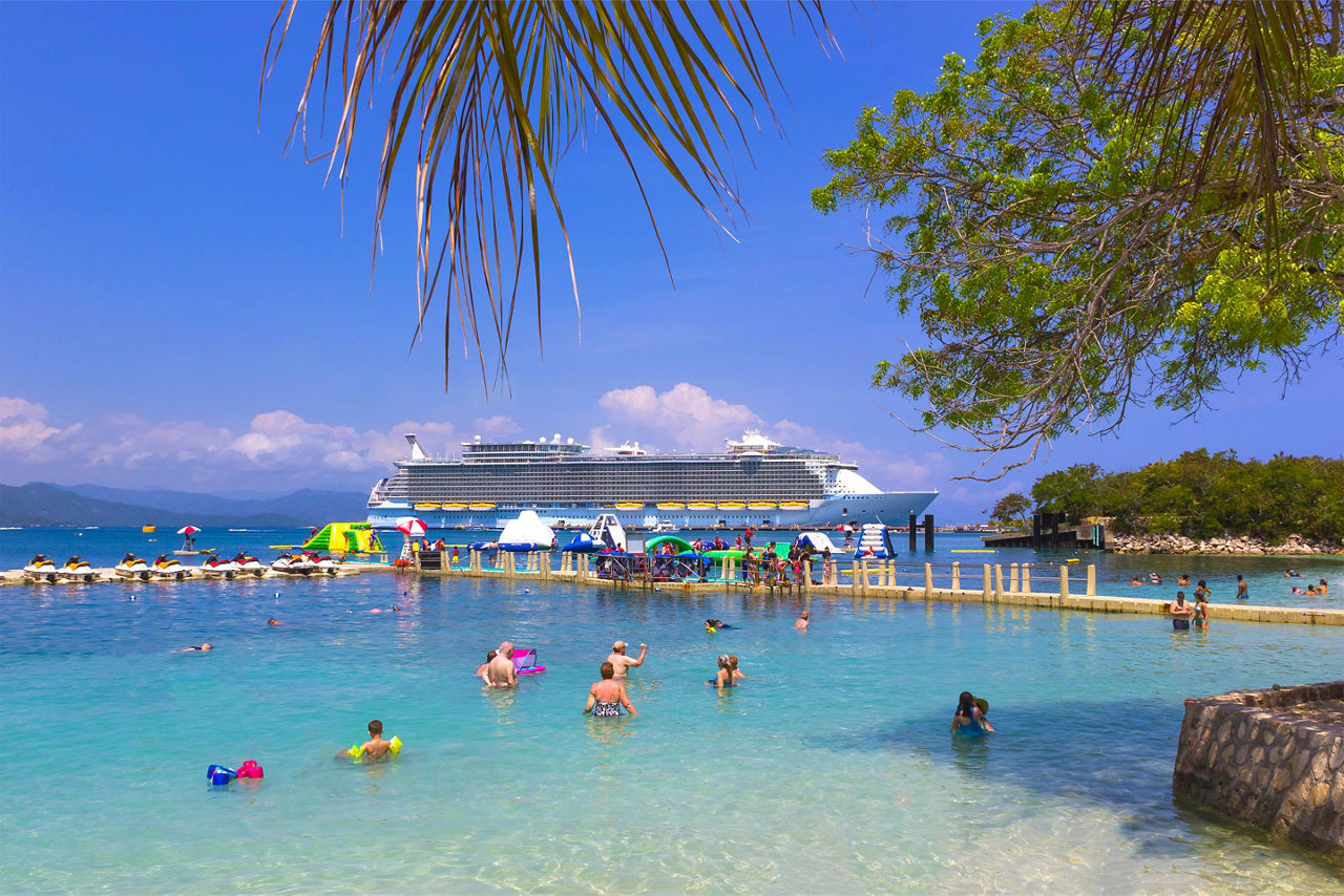 Vacation travelers a on private island beach day. Labadee. Caption: Enjoy a beautiful day at Labadee.