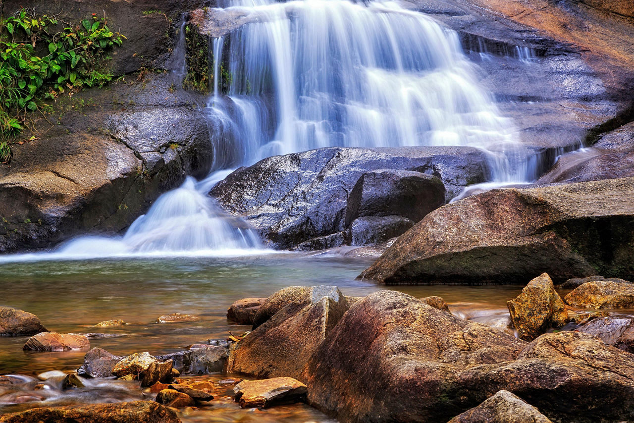 Seven wells waterfall with rocks into a stream of water in Langkawi, Malaysia