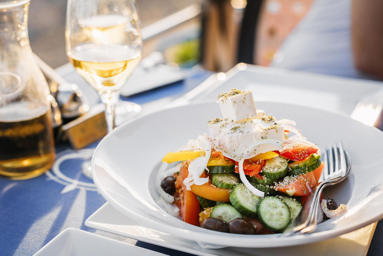 Greek salad with fresh cucumbers, tomatoes, basil and olives, in Limassol, Cyprus