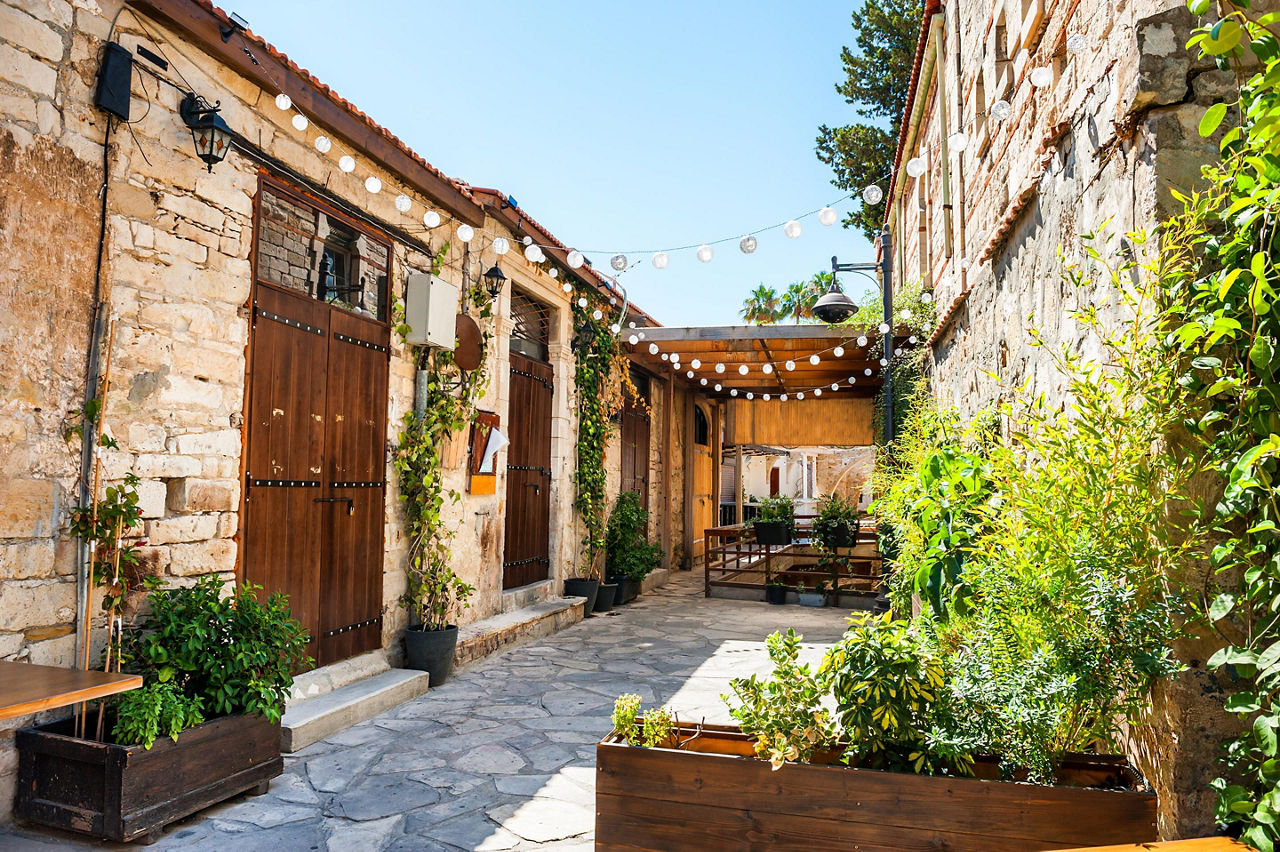 Beautiful old street decorated with plants and lights in Limassol, Cyprus