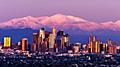 Skyline of LA with mountains behind the city at sunset. Los Angeles.