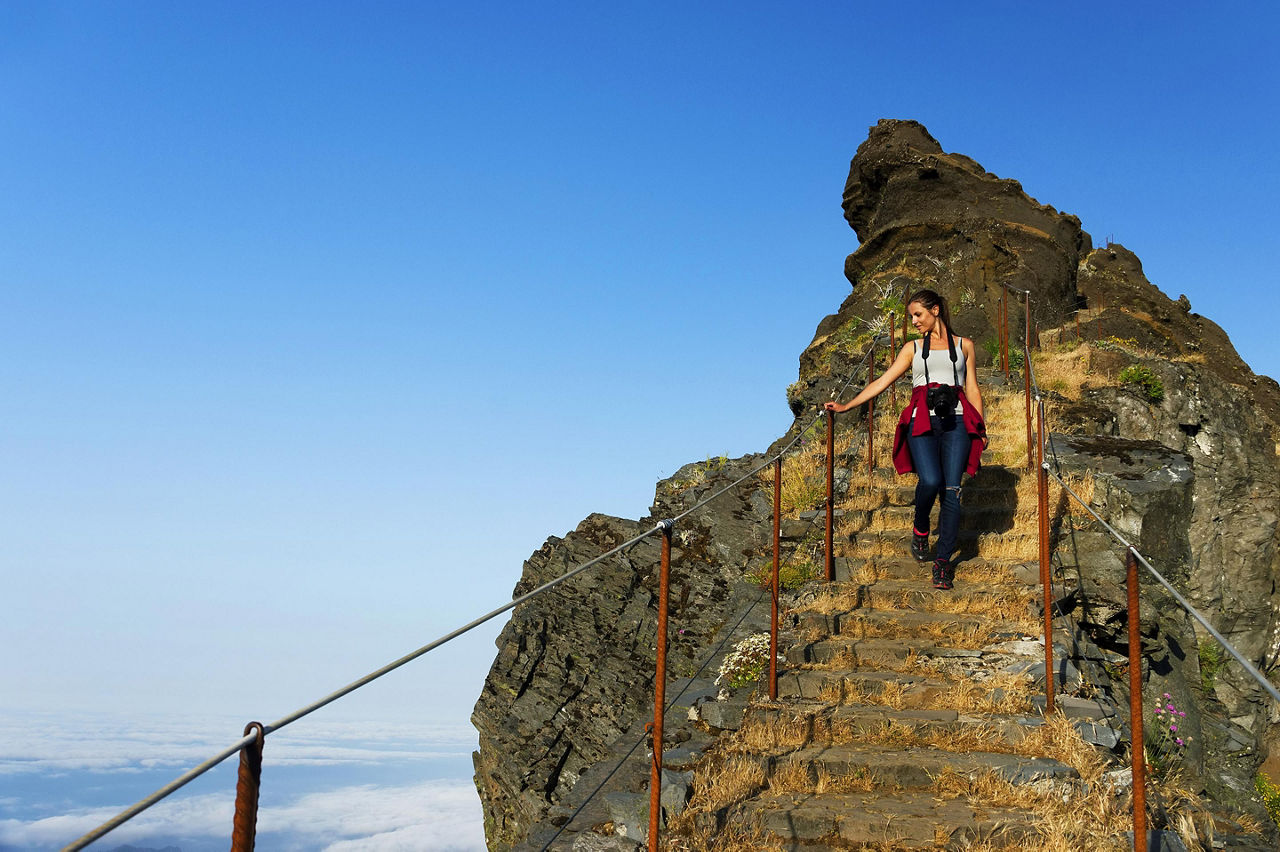 A woman climbing the staircase at Pico de Areeiro in Madeira (Funchal), Portugal