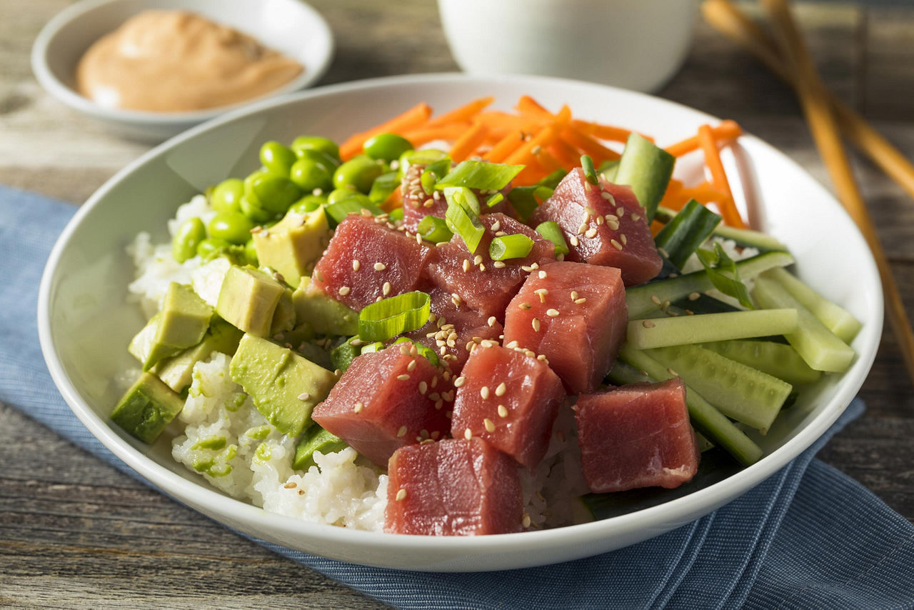 A healthy poke bowl filled with ahi tuna, avocado, veggies, and rice in Hawaii