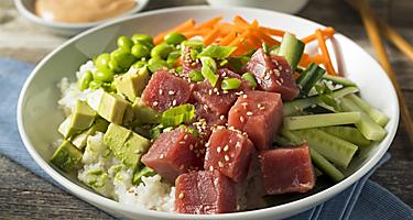 A healthy poke bowl filled with ahi tuna, avocado, veggies, and rice in Hawaii