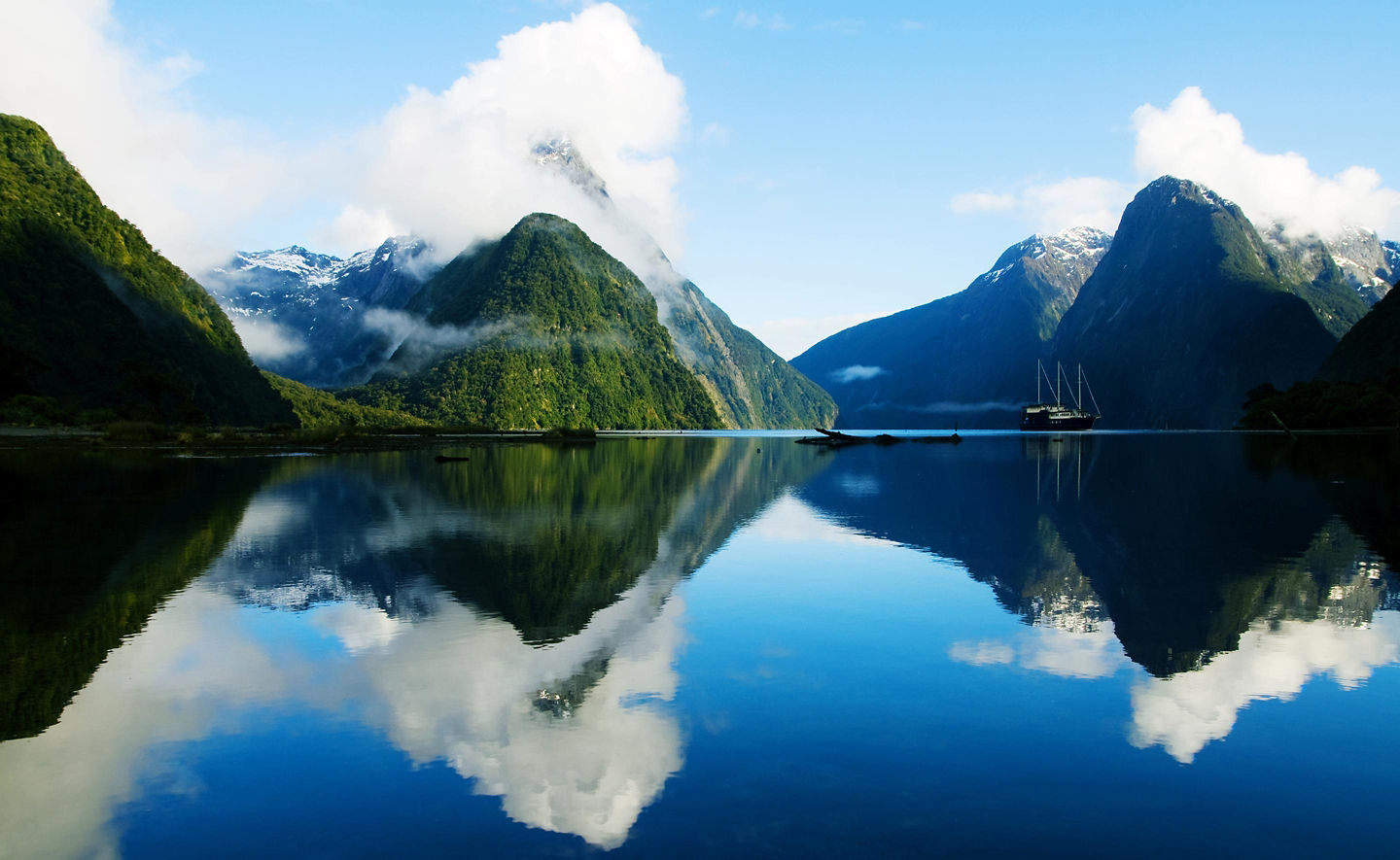 Mitre Peak rises sharply above calm Milford Sound. - Milford Sound, New Zealand