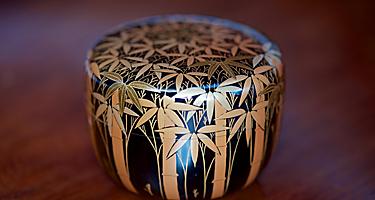 Vintage Japanese black lacquer tea caddy with auspicious gold makie bamboo forest design, used in the Japanese Tea Ceremony